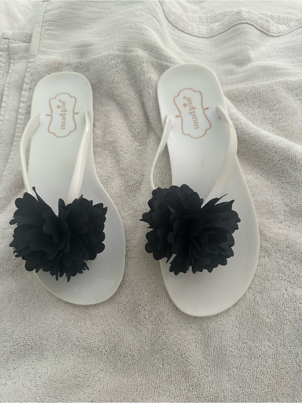 Mud Pie White Flip Flop Sandals with Black Flower Embellishments